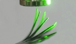 Incident light from right causes an elastomer film to deflect in a magnetic field Incident light from right causes an elastomer film to deflect in a magnetic field