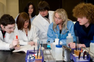 A group of university students working on a science project in class