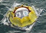 Testing solar cell performance for underwater applications Solar cells mounted inside a glass sphere are lowered into the water to a depth of 9 meters Instrumentation records both the solar cell performance and the solar spectrum underwater Credit US Nava