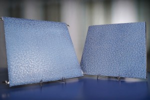 Freely combinable facade elements with decorative filmon the left, a PV module and, on the right, a sheet metal facade element without PV functionality
