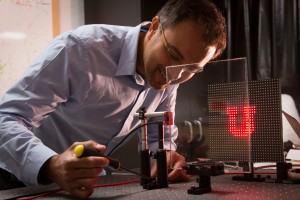 University of Utah electrical and computer engineering associate professor Rajesh Menon has discovered a way to create an optics-less camera in which a regular pane of glass or any see-through window can become the lens Photo credit Dan HixsonUniversity o University of Utah electrical and computer engineering associate professor Rajesh Menon has discovered a way to create an optics-less camera in which a regular pane of glass or any see-through window can become the lens Photo credit Dan HixsonUniversity o