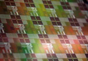 Silicon wafer with photonic-electronic microchips designed by CU research team Silicon wafer with photonic-electronic microchips designed by CU research team