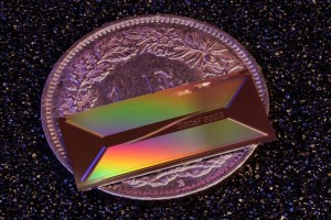 Placed on a 1 CHF coin for scale, EPFLs photonic chip shows how a laser architecture once confined to table-top systems can be shrunk to the millimeter scale Credit Zheru QiuEPFL