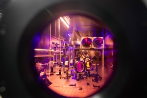 The circular glass optics and silvery metal mounts that create the laser path appear tinted pink through the round window of the crystal CREDIT Marcin SzczepanskiMichigan Engineering