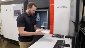 Paul Brackman loads 3D-printed metal samples into a tower for examination using an X-ray CT scan in DOEs Manufacturing Demonstration Facility at ORNL Image Brittany CramerORNL, US Dept of Energy